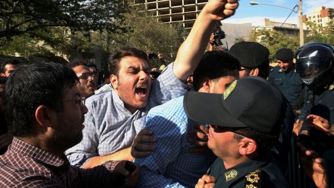 An Iranian protester chants slogans while police officers prevent him from approaching to the Saudi Arabian Embassy in Tehran, Iran, Sunday, Sept. 27, 2015,