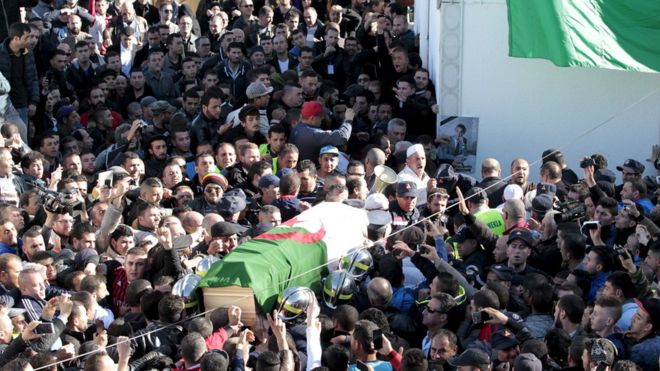 The coffin of Hocine Ait Ahmed, the Algerian leader of the Front of Socialist Forces party (FFS), is carried to be buried after prayers by his relatives and people in his hometown