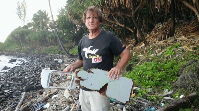 An undated handout photograph made available on 10 June 2016 by Blaine Alain Gibson showing Blaine Gibson holding new pieces of debris possibly belonging to the missing Malaysian Airlines plane MH370