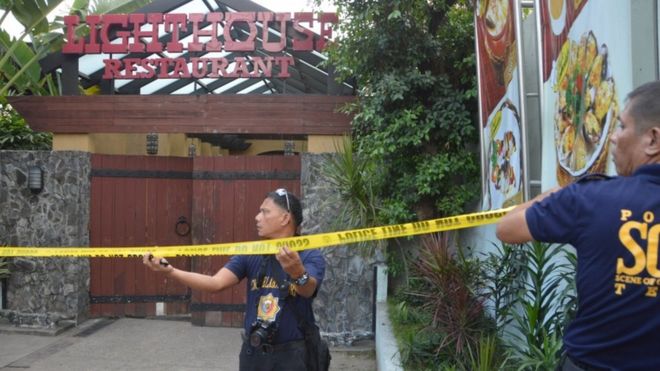 Police mark the crime scene with a yellow tape where two Chinese diplomats were killed in Cebu province, central Philippines on Wednesday Oct. 21, 2015.