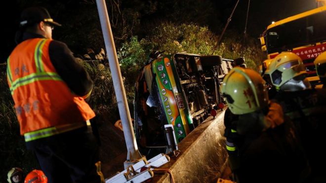 Rescuers gather around a crashed bus in Taipei, Taiwan February 13, 2017