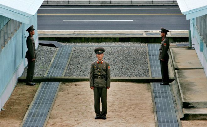 North Korean soldier stands next to the demarcation line in Panmunjom, on the border between North Korea and South Korea Tuesday 7 August 2007.