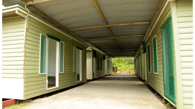 Handout photo showing six wooden huts on Manus in October 2012