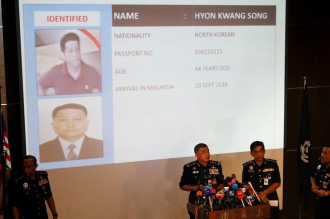 Malaysia's Inspector-General of Police Khalid Abu Bakar, center left, speaks in front of the details of one of the suspects Hyon Kwang Song.
