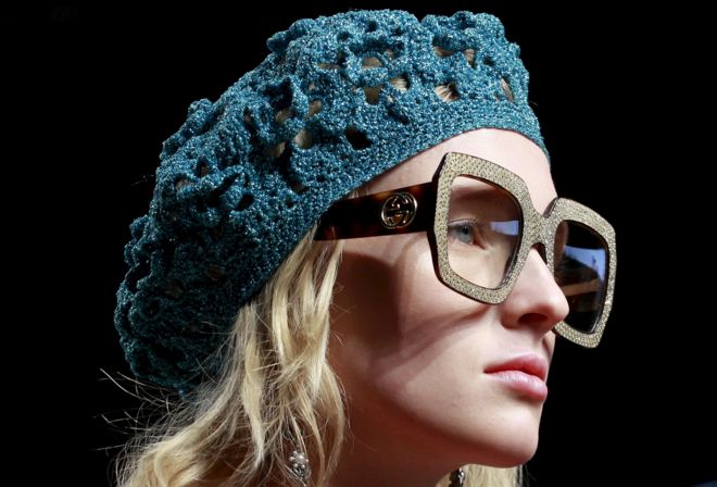Gucci model's head - wearing large glasses and a woollen hat