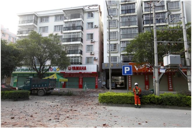 A Chinese firefighter stands at the scene of an explosion in Liucheng county in southern China's Guangxi Zhuang Autonomous Region Thursday, 1 October 2015