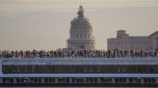 Cruise travellers on the deck of the MSC Opera cruiser as it leaves the harbour in Havana, 4 Feb 2016