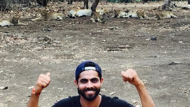 Cricketer Ravindra Jadeja poses with a pride of Asiatic lions at the Gujarat state's Gir wildlife sanctuary in western India.