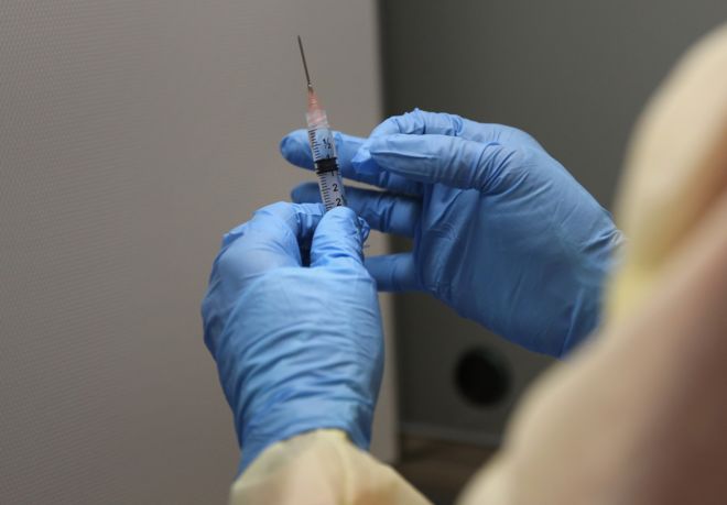 A Liberian pharmacist prepares an Ebola vaccine to be given in the vaccine trials, which were launched at Redemption Hospital, formerly an Ebola holding center, on February 2, 2015 in Monrovia, Liberia.