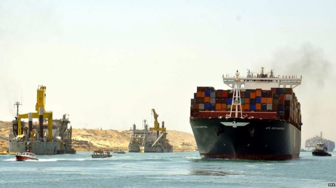 Container ships and pilot boats sail on the waterway of the New Suez Canal in Ismailia, east of Cairo, Egypt, 25 July 2015.