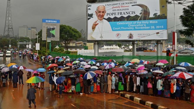 Crowds queue in the rain as they wait to access a mass by Pope Francis during his visit to Africa in Nairobi on November 26, 2015.