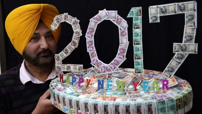 Indian artist Harwinder Singh Gill displays his new artwork made with pictures of Indian currency notes on New Years eve in Amritsar, India, 31 December 2016.