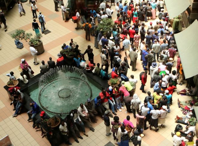 People queue to withdraw money from a bank in Harare, Zimbabwe
