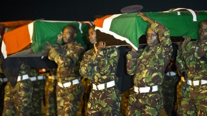 Military pallbearers carry the coffins of four Kenyan soldiers who were killed in Somalia, at a ceremony to receive their bodies which were airlifted to Wilson Airport in Nairobi, Kenya Monday, 18 January 2016