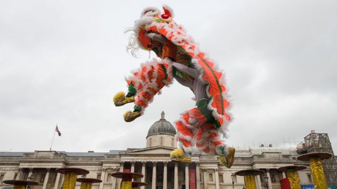 Dancers perform a Chinese flying lion dance in Trafalgar Square