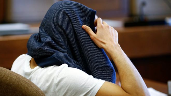 A 26-year-old Algerian who faces charges of assaults on woman during New Year"s Eve celebrations in Cologne, covers his head at a regional court in Cologne, western Germany, May 6, 2016
