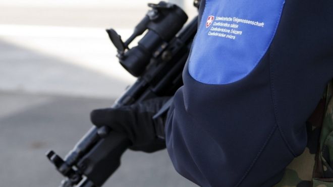 A Swiss border guard controls the area at the Bardonnex border, 11 Dec