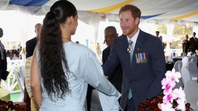 Popstar Rihanna shaking hands with Prince Harry