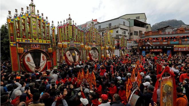 Worshippers gather around the decorated carcasses of sacrificial pigs, winners of the "holy pig" contest in Sanxia district, in New Taipei City, Taiwan, 2 February 2017.