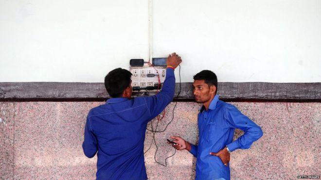 Phone charging at a station in India