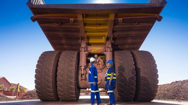Workers check a truck at Anglo American's Kolomela mine in South Africa