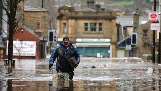 Man wades through flood water