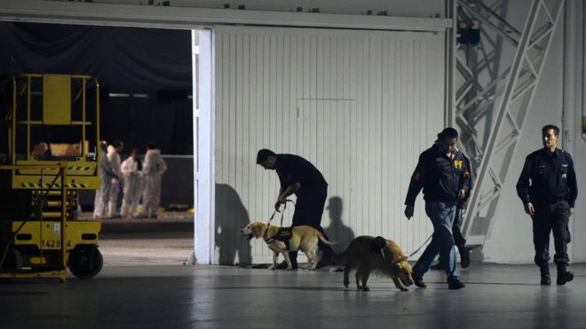 Police with their dogs are seen at the Costa Salguero event venue in Buenos Aires.