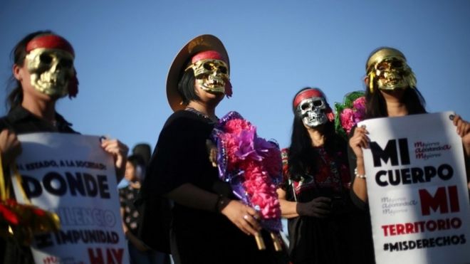 Activists take part in a march to protest violence against women and the murder of a 16-year-old girl in a coastal town of Argentina last week, at Revolucion monument, in Mexico City, Mexico, October 19, 2016