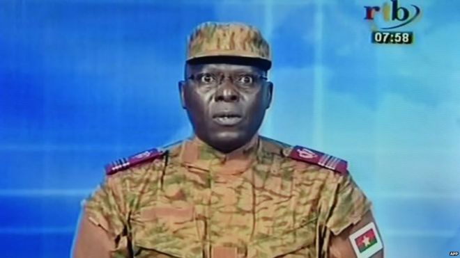 A picture taken on September 17, 2015 shows a TV screen during the broadcast of the speech of Lieutenant-colonel Mamadou Bamba announcing that a new 