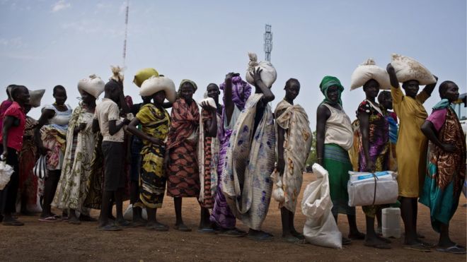 Women who have fled fighting in South Sudan queue for food aid, 19 October 2016