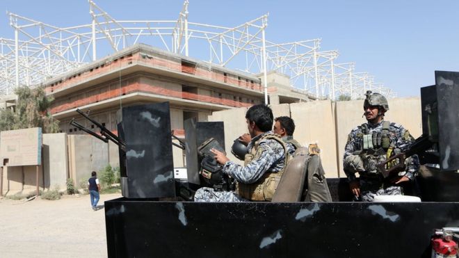 Iraqi security forces guard the entrance to a sports stadium under construction in Baghdad's Sadr City district (2 September 2015)