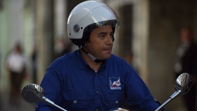 The presidential candidate for the National Front of Convergence (FCN) party, Jimmy Morales, drives on a motorbike during the closing rally of his campaign, in Guatemala City on 22 October, 2015