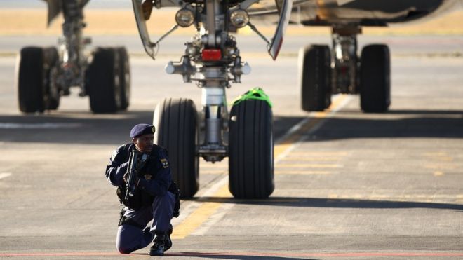 Armed Police officers guard the plane before the players disembark as the England team arrive at Johannesburg's OR Tambo International Airport for the 2010 FIFA World Cup on June 3, 2010 in Johannesburg, South Africa.