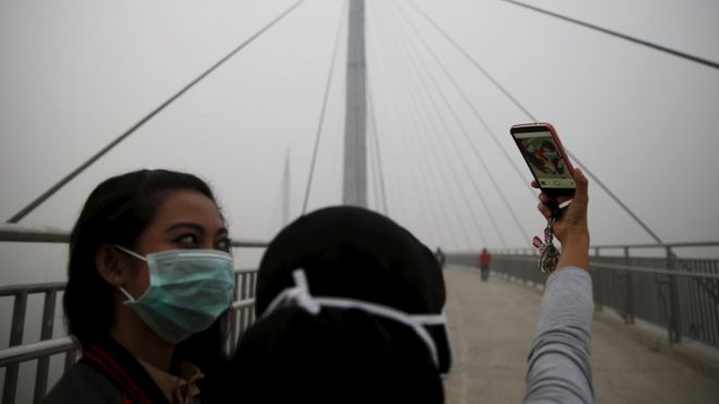 Girls take a selfie on bridge in Pekanbaru, Indonesia (14 Sept 2015)