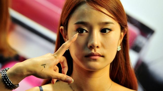 A South Korean model having her make-up applied