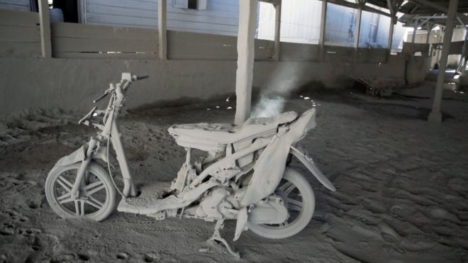 A scooter in a warehouse, covered in volcanic ash, in Gamber village in Karo on 23 May 2016