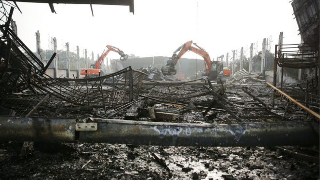 Excavators tear down a burnt down hall at Messe Duesseldorf, Germany, 8 June 2016