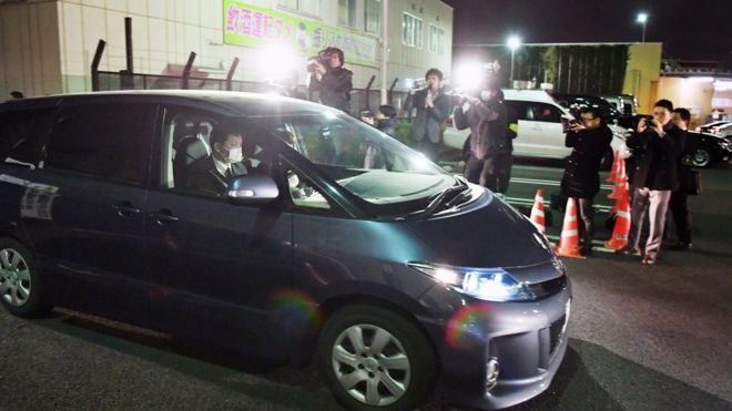 In this Sunday, March 27, 2016 photo, a police car carrying a girl who had been abducted, leaves the police headquarters in Niiza, Saitama prefecture, near Tokyo