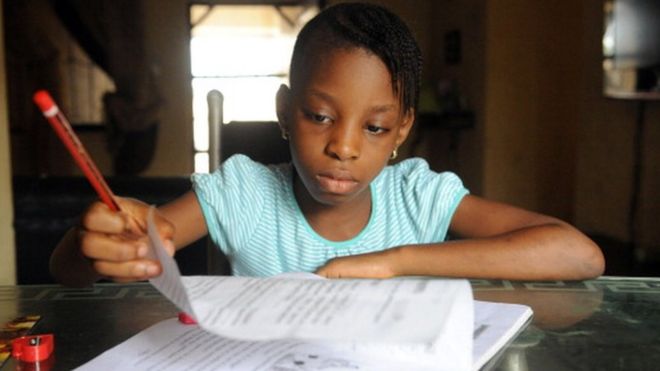 USE Omoze Ogwogho, 7, a pupil of the Christower International Schools, one of Nigeria's private schools, does her homework on June 8, 2013 at home in the southwestern city of Ibafo, Ogun State.