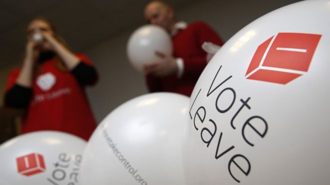 Campaign workers blow up balloons advertising the Vote Leave campaign