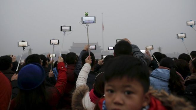 People held their mobile phone cameras aloft