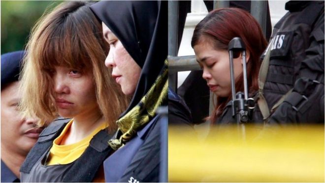 Doan Thi Huong (left) and Siti Aisyah (right) outside court in Malaysia, surrounded by armed guards. 1 March 2017.
