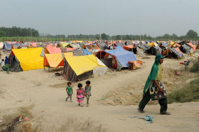 In this photograph taken on October 7, 2013 an Indian Muslim woman walks at a relief camp in Malakpur, a village in Shamli district of Uttar Pradesh.