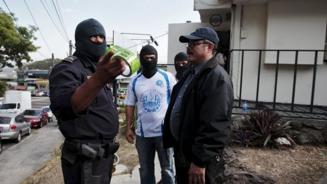 Police investigators stand outside the Mossack Fonseca offices in San Salvador, El Salvador April 8, 2016