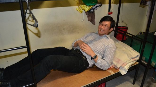 This photo uploaded by the Singapore Ministry of Manpower shows Minister of State Teo Ser Luck lying on a bed of a migrant construction worker