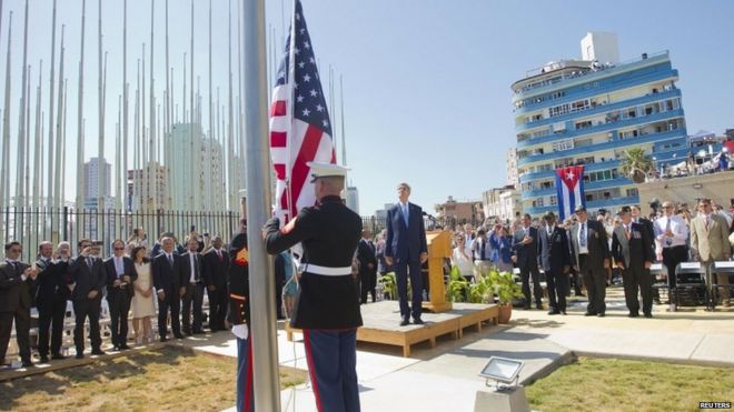 US Secretary of State John Kerry (C) stands with other dignitaries as members of the US Marines raise the U.S. flag over the newly reopened embassy in Havana, Cuba, on 14 August 2015.