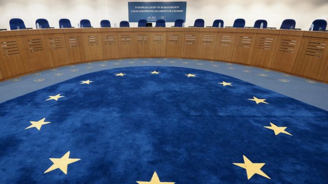The chamber of the ECHR is seen in this file photo, with the European flag on the floor and seat for the panel in a circle around it