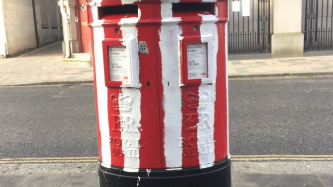 The post box painted with Saints stripes in Bargate