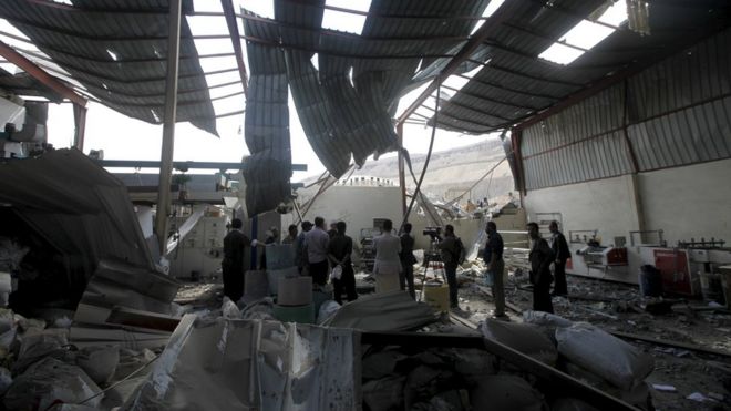 Journalists inspect the damage at a tea factory after it was hit by Saudi-led air strikes in Yemen"s capital Sanaa January 30, 2016