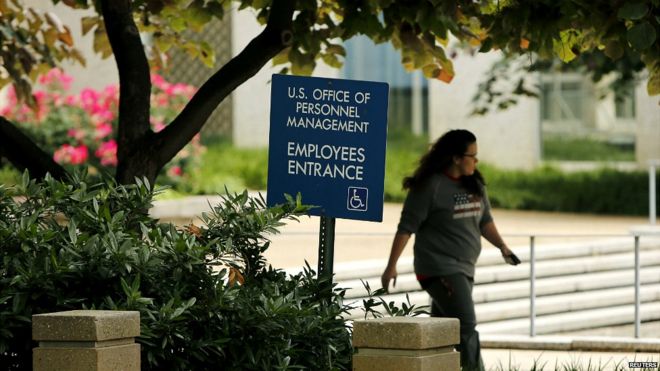 An employee of the US Office of Personnel Management departs the building in Washington - 5 June 2015